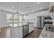 Modern kitchen featuring white cabinets, stainless steel appliances, and a large island at 450 Shale Creek Dr, Durham, NC 27703