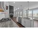 Modern kitchen with island, stainless appliances, and open to living room at 450 Shale Creek Dr, Durham, NC 27703