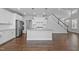 Open kitchen features stainless steel appliances, a center island, and white cabinets for ample storage at 450 Shale Creek Dr, Durham, NC 27703