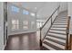 Bright living room boasts large windows, high ceilings, and elegant staircase at 450 Shale Creek Dr, Durham, NC 27703