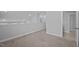 Loft with neutral carpet, white trim, and baseboards, with an open doorway at 450 Shale Creek Dr, Durham, NC 27703