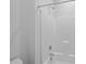 All white, tiled shower enclosure with mounted shower head and handle at 450 Shale Creek Dr, Durham, NC 27703