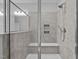 Tiled glass-enclosed shower featuring built-in shelves and seating at 450 Shale Creek Dr, Durham, NC 27703