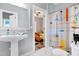 Hall bathroom showcasing a colorful shower curtain and natural lighting at 4793 Overhills Rd, Spring Lake, NC 28390