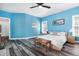 Large bedroom with bright blue walls, wood floors, and lots of natural light at 4793 Overhills Rd, Spring Lake, NC 28390