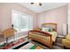 Cozy bedroom with natural lighting, wood floors, and a desk space at 4793 Overhills Rd, Spring Lake, NC 28390