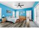 Bright bedroom with wood flooring, a ceiling fan, and access to an ensuite bathroom at 4793 Overhills Rd, Spring Lake, NC 28390