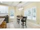 Eat-in kitchen area featuring modern lighting, large windows, and a dining table with seating at 4793 Overhills Rd, Spring Lake, NC 28390