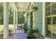Welcoming covered porch with seating, charming details, and exterior lighting creates a cozy outdoor space at 4793 Overhills Rd, Spring Lake, NC 28390