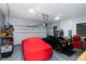 Spacious garage featuring two cars, storage shelves, and bright overhead lighting at 4793 Overhills Rd, Spring Lake, NC 28390