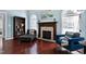 Cozy living room with fireplace, hardwood floors, bookshelves, and comfortable seating creates a relaxing retreat at 4793 Overhills Rd, Spring Lake, NC 28390