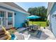 Outdoor patio featuring a table and chairs, umbrella, and blue siding at 4793 Overhills Rd, Spring Lake, NC 28390