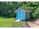 Outdoor shed in a lush green backyard, surrounded by mature trees at 4793 Overhills Rd, Spring Lake, NC 28390