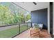 Balcony features outdoor seating and views of the well-maintained lawn and surrounding trees at 501 S Bloodworth St # 101, Raleigh, NC 27601