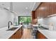 Open-concept kitchen with island, stainless steel appliances, and view into the living area at 501 S Bloodworth St # 101, Raleigh, NC 27601