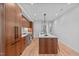 Modern kitchen with wood cabinetry, a large island, and stainless steel appliances at 501 S Bloodworth St # 101, Raleigh, NC 27601
