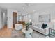 Open living room with hardwood floors, modern furnishings, and views into the kitchen area at 501 S Bloodworth St # 101, Raleigh, NC 27601