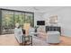 Bright living room featuring modern furniture, a large window with wooded view, and hardwood floors at 501 S Bloodworth St # 101, Raleigh, NC 27601