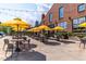 Outdoor patio seating area includes modern tables, chairs, and vibrant yellow umbrellas at 501 S Bloodworth St # 101, Raleigh, NC 27601