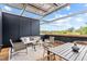 Relaxing covered patio featuring a seating area, dining table, and neighborhood views at 501 S Bloodworth St # 101, Raleigh, NC 27601