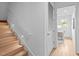 Bright stairway with wooden steps and railing leading to the upper floor at 501 S Bloodworth St # 101, Raleigh, NC 27601