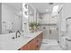 Sleek bathroom with a double vanity, wood cabinets, modern fixtures, and a glass-enclosed shower at 501 S Bloodworth St # 104, Raleigh, NC 27601