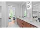 Modern bathroom featuring a double vanity with wood cabinets, a glass-enclosed shower, and stylish mirrors at 501 S Bloodworth St # 104, Raleigh, NC 27601
