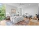 Airy bedroom features large windows, modern furnishings, and a comfortable queen bed at 501 S Bloodworth St # 104, Raleigh, NC 27601