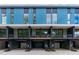 Modern townhome exterior featuring blue accents, large windows, private balconies, and convenient garage parking at 501 S Bloodworth St # 104, Raleigh, NC 27601