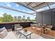 Relaxing rooftop patio with stylish furniture, a dining table, and city skyline views at 501 S Bloodworth St # 104, Raleigh, NC 27601