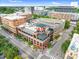 Wide aerial view of building and parking lot with a cityscape beyond at 510 Glenwood Ave # 510, Raleigh, NC 27603