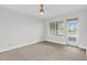 A light filled bedroom with carpet floors, a ceiling fan, and access to a balcony at 510 Glenwood Ave # 510, Raleigh, NC 27603