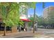 Exterior of building with sidewalk and street view with lush tree line and streetlights on a sunny day at 510 Glenwood Ave # 510, Raleigh, NC 27603