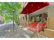 Building entrance with red stairwell, silver railings, manicured landscaping, and sidewalks at 510 Glenwood Ave # 510, Raleigh, NC 27603