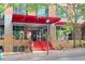 Building entrance with bright red awning and stairway, complemented by meticulous landscaping and stone accents at 510 Glenwood Ave # 510, Raleigh, NC 27603