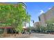 Exterior of building and sidewalk with lush trees and blue sky at the corner of a city street at 510 Glenwood Ave # 510, Raleigh, NC 27603