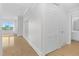 Hallway with a bathroom visible at the end, closets, and a door with glass panels at 510 Glenwood Ave # 510, Raleigh, NC 27603