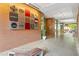 Hallway with exposed brick, built in wooden benches, and concrete flooring in a well-lit common area at 510 Glenwood Ave # 510, Raleigh, NC 27603