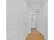 Hallway with white doors leading to bathroom, storage, and other rooms at 510 Glenwood Ave # 510, Raleigh, NC 27603