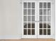 A pair of white french doors offer natural light and charm in this interior at 510 Glenwood Ave # 510, Raleigh, NC 27603