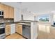 Bright kitchen with stainless appliances, light wood cabinetry, and a mosaic backsplash at 510 Glenwood Ave # 510, Raleigh, NC 27603