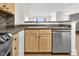 Close up of kitchen area with stainless appliances, undermount sink, and breakfast bar at 510 Glenwood Ave # 510, Raleigh, NC 27603