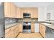 Kitchen featuring light wood cabinets and stainless steel appliances at 510 Glenwood Ave # 510, Raleigh, NC 27603