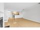 Open living room featuring wood floors connecting to the kitchen with stainless appliances at 510 Glenwood Ave # 510, Raleigh, NC 27603