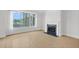 Bright living room featuring a fireplace, large window, and wood floors at 510 Glenwood Ave # 510, Raleigh, NC 27603
