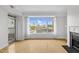 Bright living room features large windows offering city views, a fireplace, and hardwood floors at 510 Glenwood Ave # 510, Raleigh, NC 27603