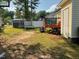 Spacious backyard featuring a deck, storage shed, trampoline, and lawn equipment at 5404 Drum Inlet Pl, Raleigh, NC 27610