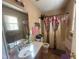Functional bathroom with a vanity, toilet, and a bathtub with a shower curtain, providing essential amenities at 5404 Drum Inlet Pl, Raleigh, NC 27610