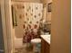 Cozy bathroom with a sink, toilet, and a bathtub with a shower curtain, offering essential functionality and comfort at 5404 Drum Inlet Pl, Raleigh, NC 27610