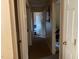Hallway with multiple doorways and neutral walls, offering access to different areas of the home at 5404 Drum Inlet Pl, Raleigh, NC 27610
